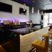 A modern bar with flat screens and textured panels at Kuroshio. Melanie Maxwell I AnnArbor.com
